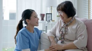 Older adults walking with a caregiver in a well-lit hallway equipped with grab bars and clear pathways.